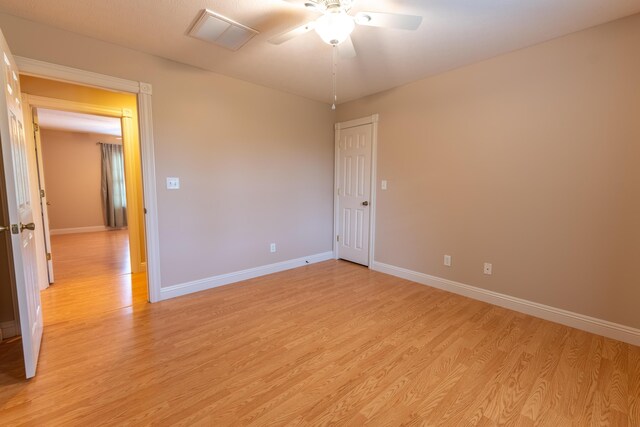 empty room with light hardwood / wood-style floors and ceiling fan