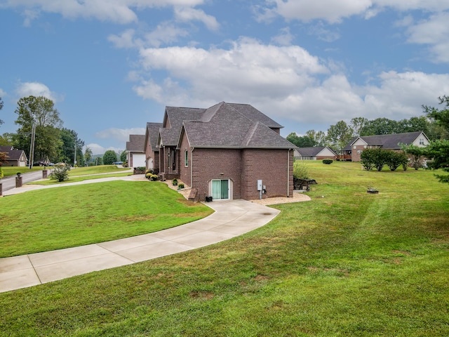 view of side of property with a garage and a yard