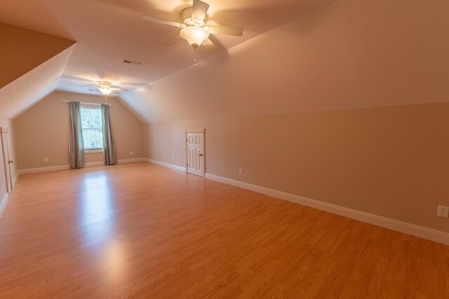 additional living space with lofted ceiling, ceiling fan, and light hardwood / wood-style floors