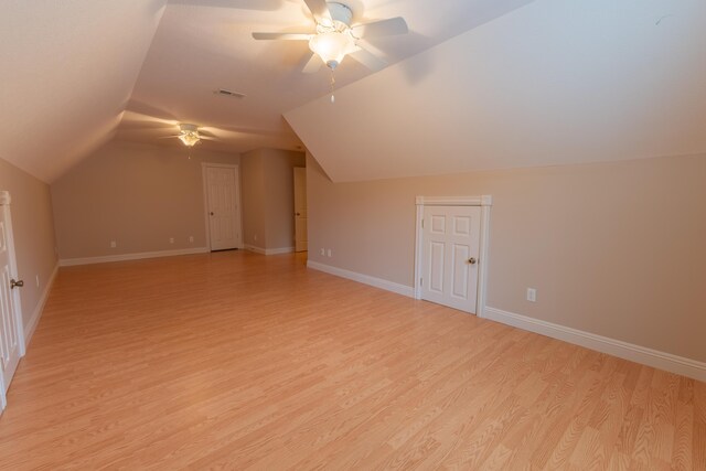 bonus room featuring light hardwood / wood-style flooring, lofted ceiling, and ceiling fan