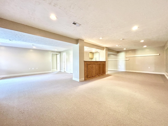 244 Water Cliff Dr, Somerset, KY 42503 - finished below grade area featuring visible vents, baseboards, a textured ceiling, recessed lighting, and light carpet