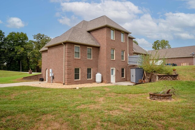 rear view of property with a lawn