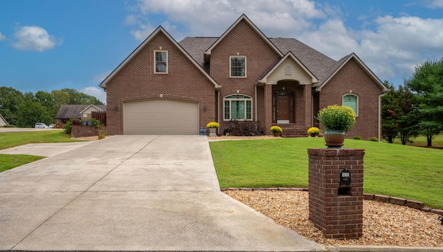 view of front property featuring a front lawn and a garage