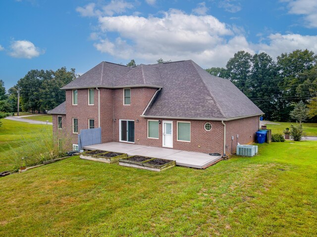 back of property featuring cooling unit, a lawn, and a patio