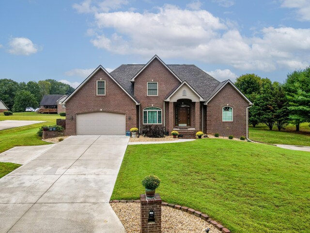 view of front of home with a garage and a front lawn