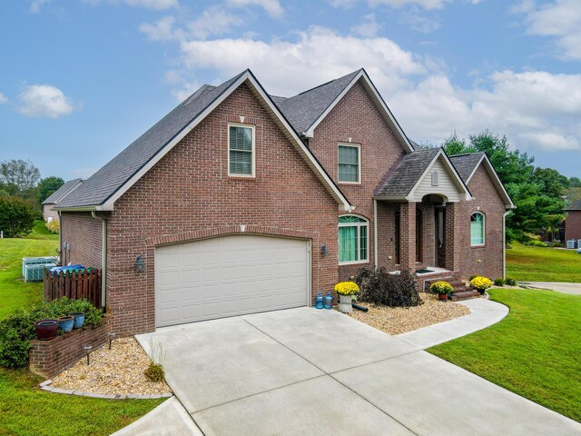 view of front of property with a front yard and a garage