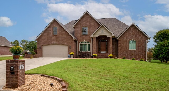244 Water Cliff Dr, Somerset, KY 42503 - traditional-style house featuring concrete driveway, central air condition unit, a front yard, brick siding, and a garage