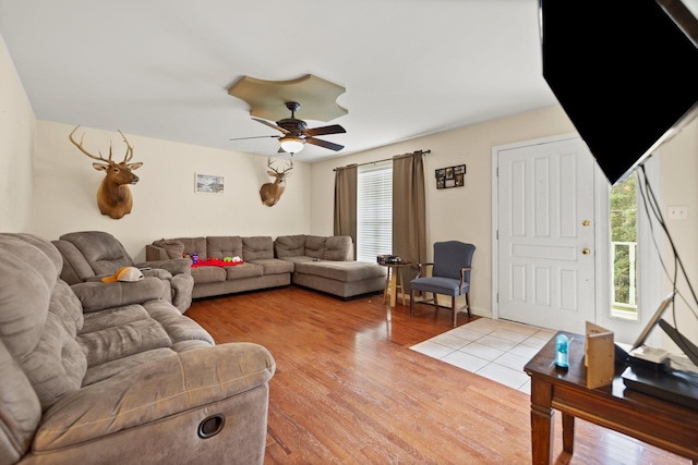 living room featuring ceiling fan and light wood finished floors