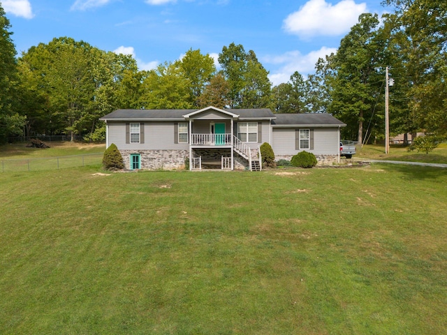 view of front of property featuring a wooden deck and a front yard