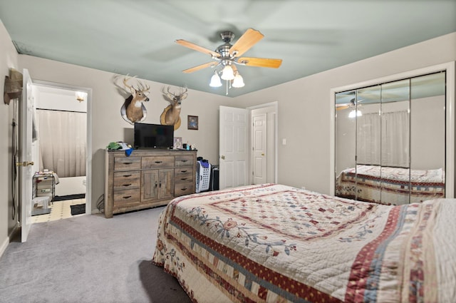 carpeted bedroom featuring ceiling fan and a closet