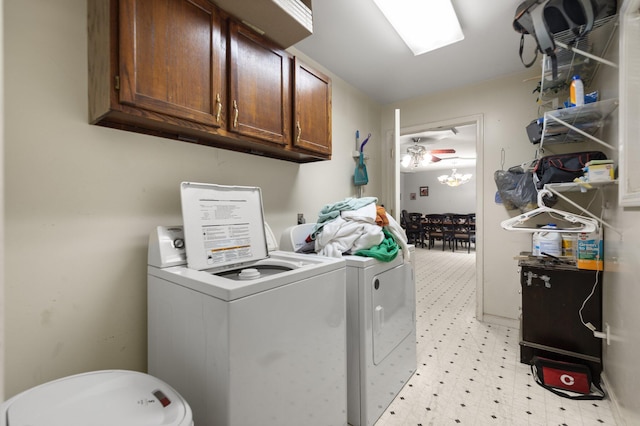 laundry room with washing machine and clothes dryer, light flooring, and cabinet space