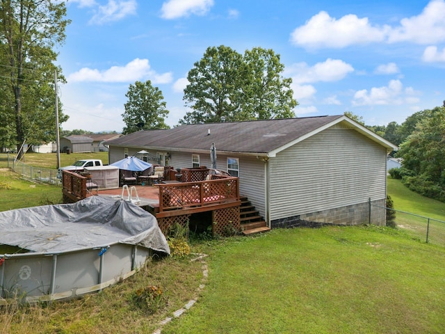 back of property featuring a wooden deck, crawl space, and a covered pool