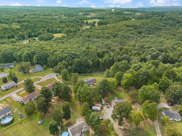 aerial view of property and surrounding area featuring a forest