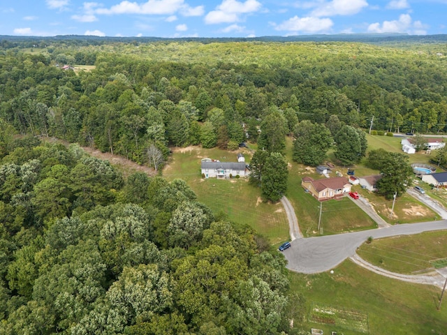 aerial view of property's location with a heavily wooded area