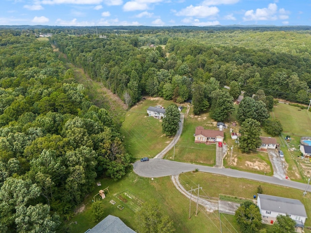 aerial view of property's location featuring a forest