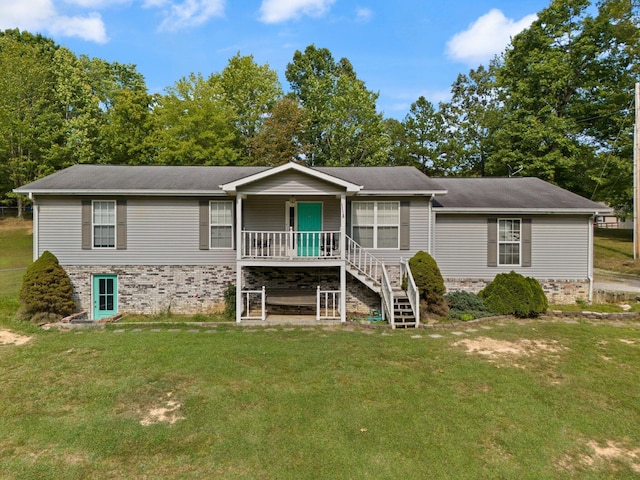 view of front of house with a front lawn, covered porch, and stairs