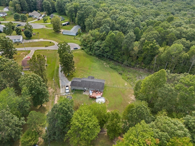 view of property location featuring a forest
