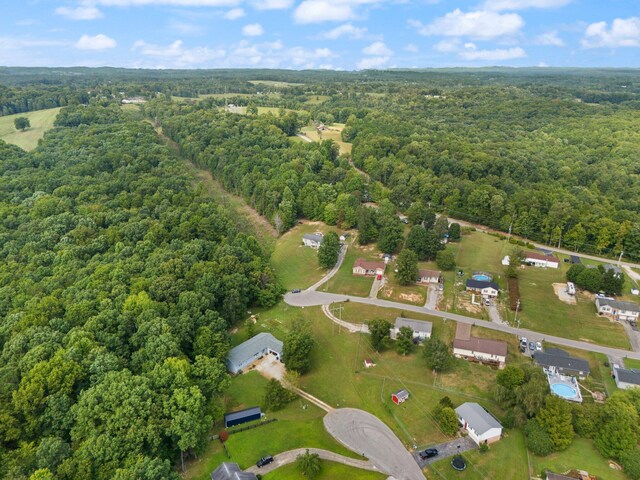 view of property location featuring a forest