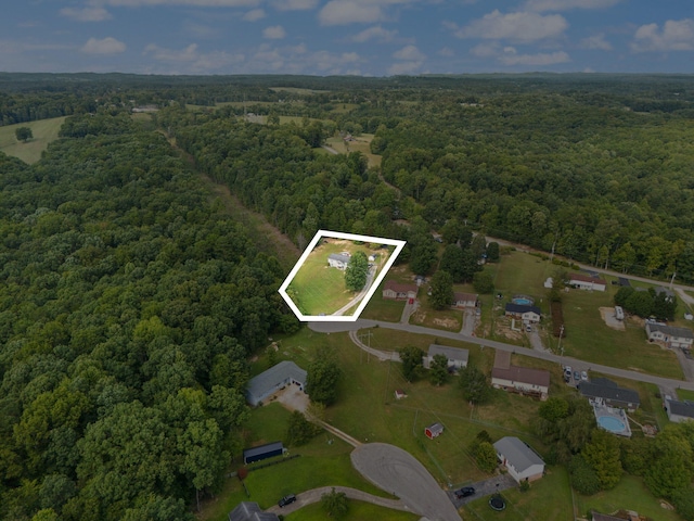 aerial view of property's location featuring a forest and property boundaries highlighted
