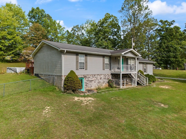 view of front of property with a wooden deck and a front lawn