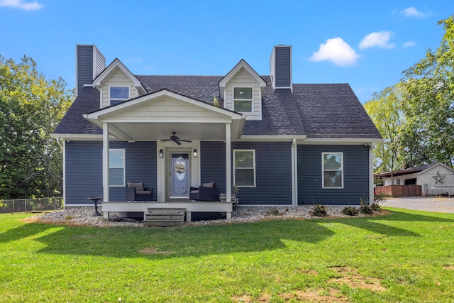 view of front of house with a front lawn, ceiling fan, and covered porch