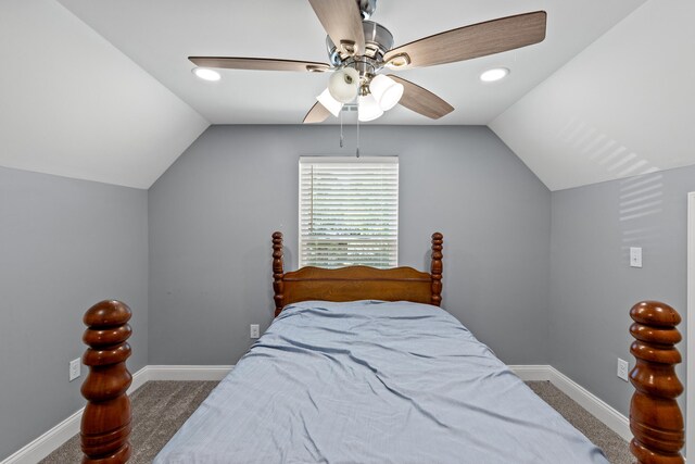 carpeted bedroom with vaulted ceiling and ceiling fan