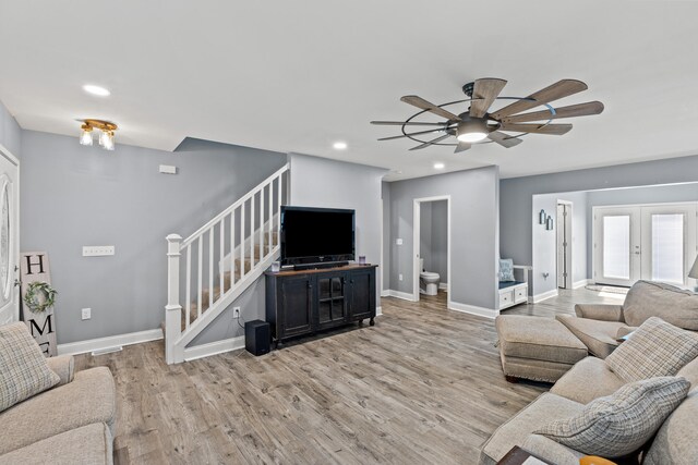 living room featuring french doors, hardwood / wood-style flooring, and ceiling fan