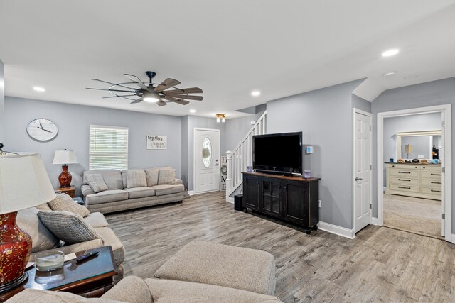 living room featuring ceiling fan and light hardwood / wood-style floors