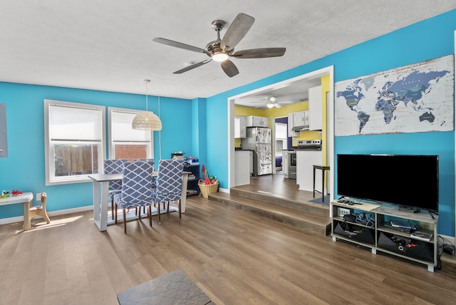 interior space featuring a textured ceiling, ceiling fan, and dark hardwood / wood-style floors