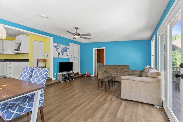 living room with hardwood / wood-style floors and ceiling fan