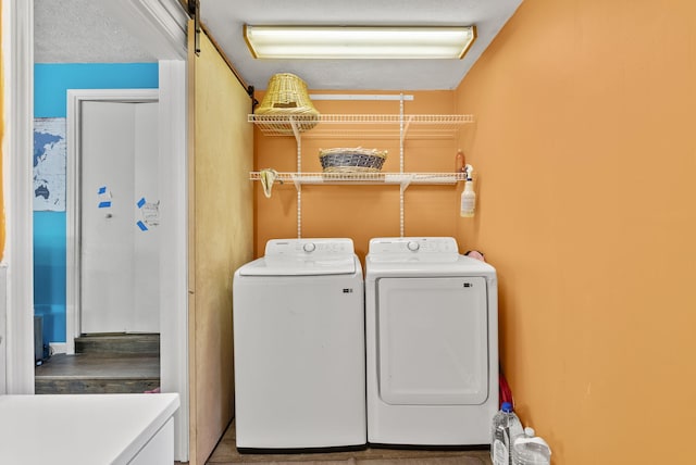 laundry room featuring independent washer and dryer and a textured ceiling