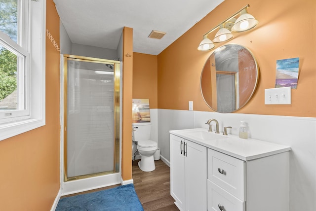 bathroom featuring vanity, toilet, hardwood / wood-style floors, and an enclosed shower