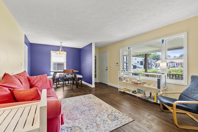 living room featuring a textured ceiling and dark hardwood / wood-style floors