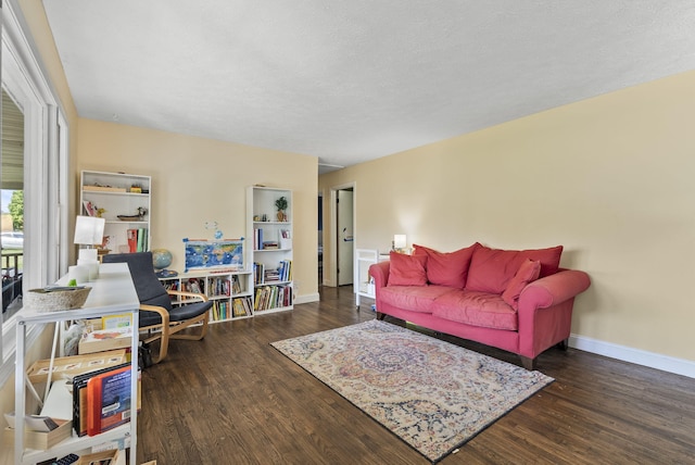 living room with a textured ceiling and dark wood-type flooring