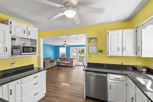 kitchen featuring a textured ceiling, ceiling fan, appliances with stainless steel finishes, and white cabinetry