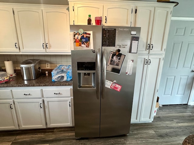 kitchen featuring dark wood-type flooring, white cabinets, stainless steel fridge with ice dispenser, and tasteful backsplash