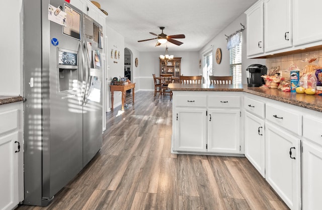 kitchen featuring stainless steel fridge, white cabinetry, kitchen peninsula, and ceiling fan