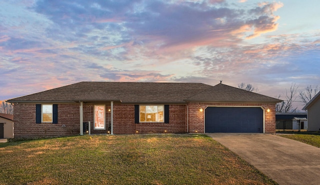 ranch-style house with a lawn and a garage