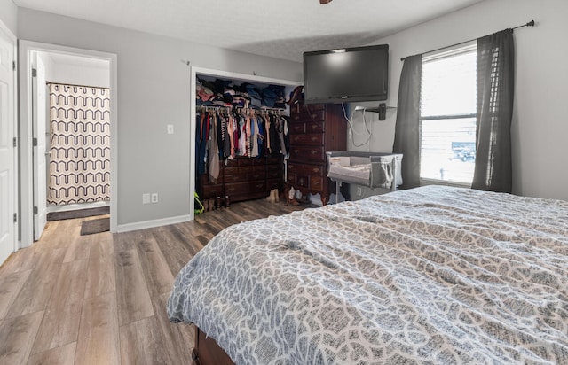 bedroom featuring a textured ceiling, hardwood / wood-style flooring, and a closet