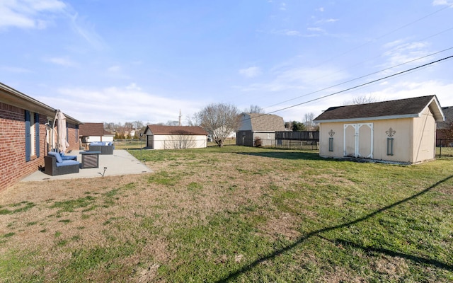 view of yard featuring a patio and a storage unit