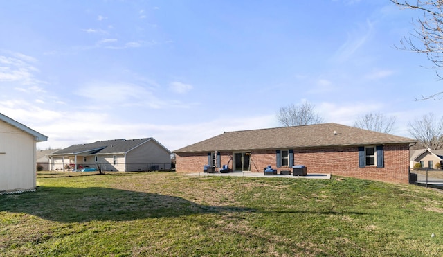 rear view of property featuring a patio area and a yard