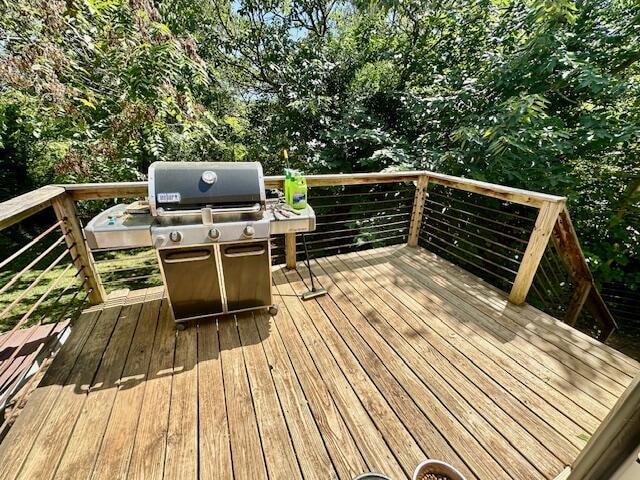 wooden terrace featuring grilling area