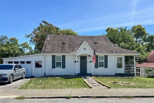 view of front of home with a garage and a front lawn