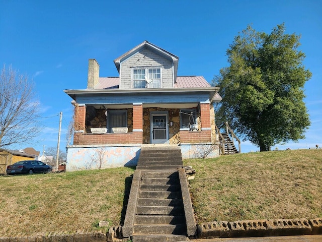 bungalow-style house with a front lawn and covered porch