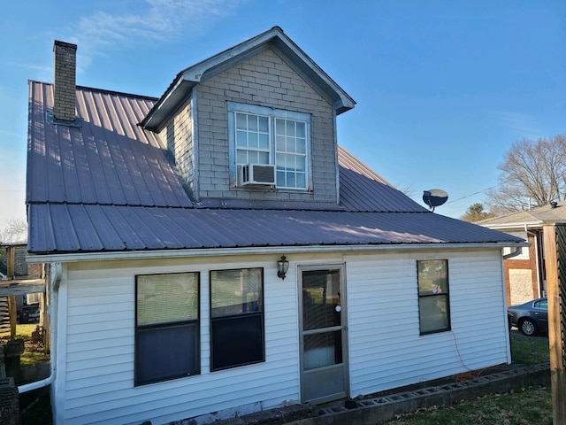 rear view of property with cooling unit