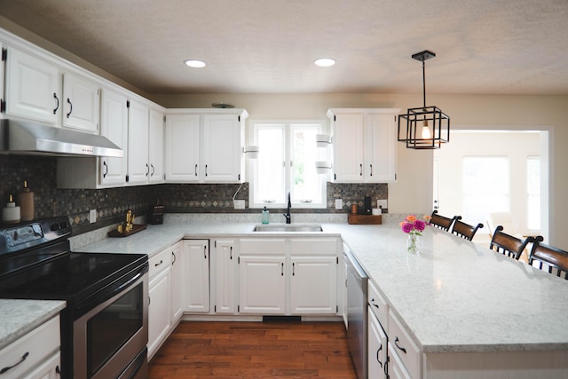 kitchen with appliances with stainless steel finishes, dark hardwood / wood-style flooring, sink, and white cabinets