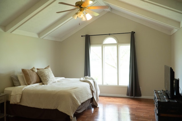 bedroom with multiple windows, ceiling fan, hardwood / wood-style floors, and lofted ceiling with beams