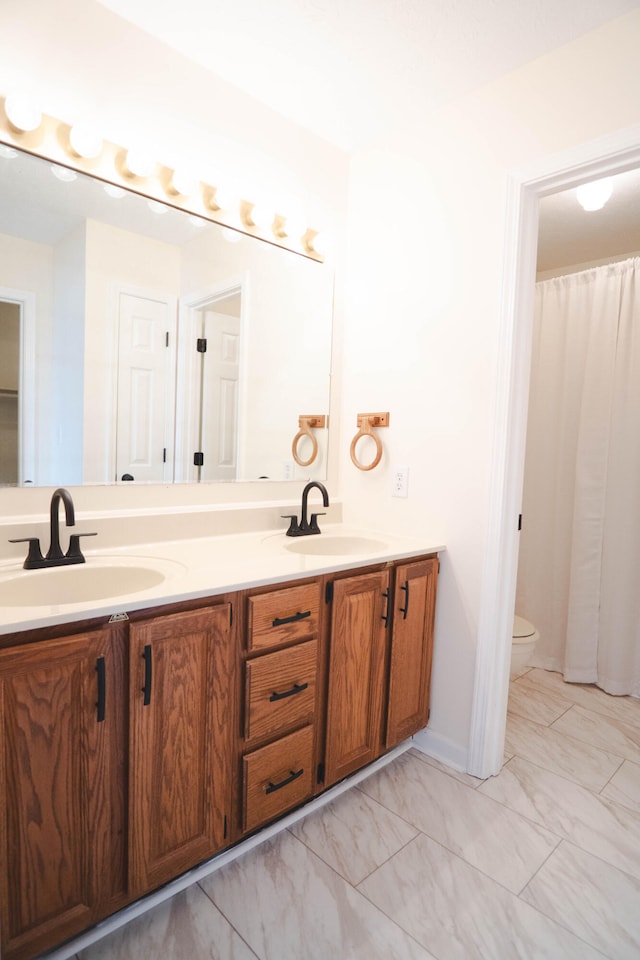 bathroom with vanity, toilet, and a shower with curtain