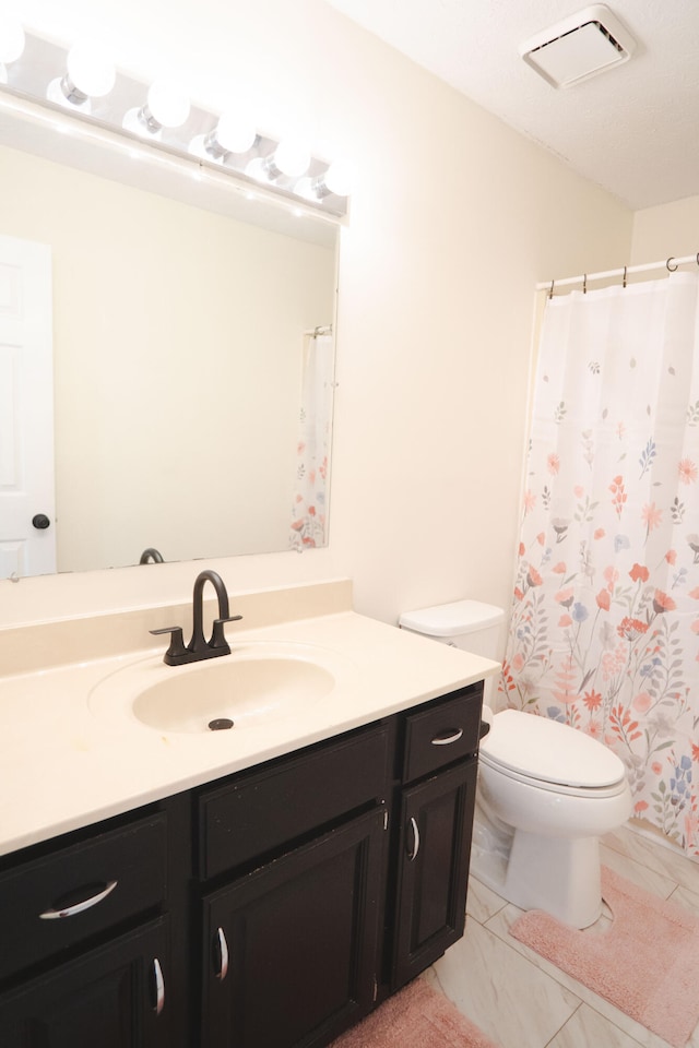 bathroom with vanity, toilet, and a shower with curtain