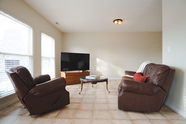 living room featuring light tile patterned floors and a healthy amount of sunlight